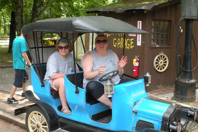 Michelle & Gracie in an old car.